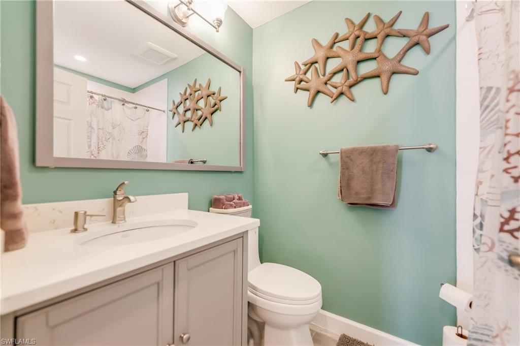 Bathroom with vanity and a shower with shower curtain