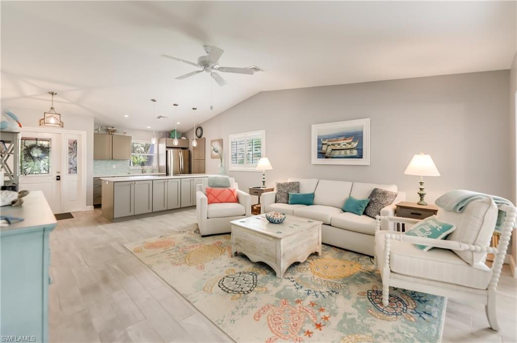 Living room with ceiling fan, lofted ceiling%2