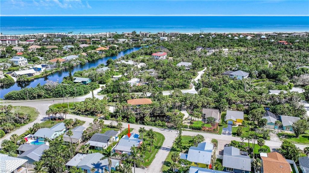 Aerial view of residential area featuring a large body of water