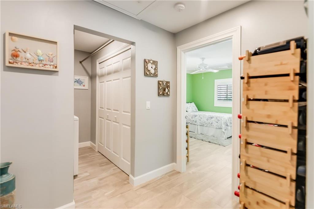 Hall with light wood-style flooring and baseboards