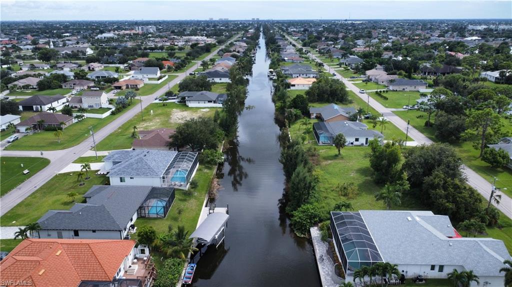 Aerial perspective of suburban area with a large body of water