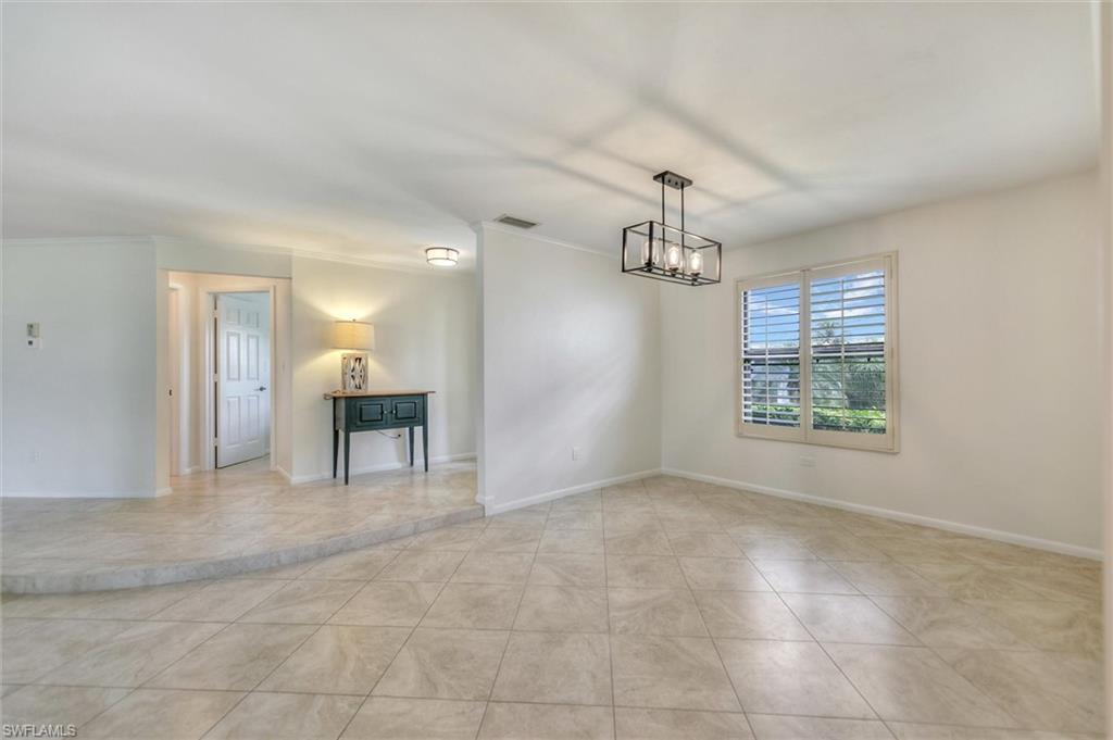 Unfurnished room featuring a ceiling fan and tile patterned flooring