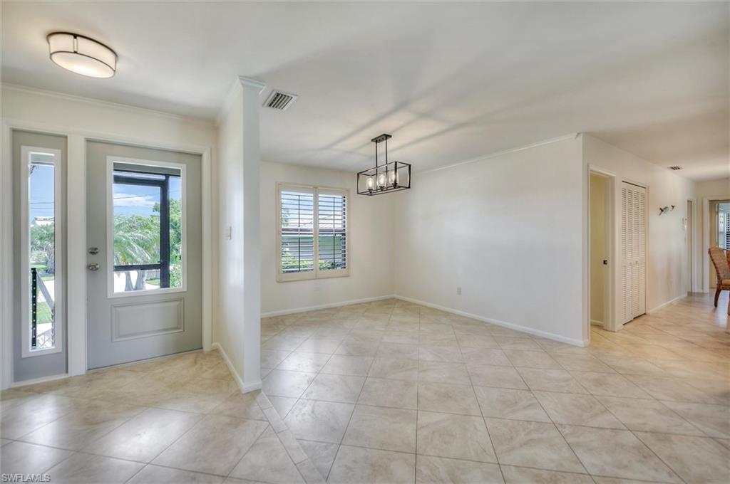 Bedroom with a ceiling fan and light tile patterned flooring