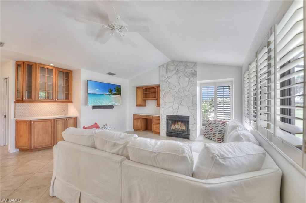 Spare room featuring a chandelier, light tile patterned floors, and crown molding