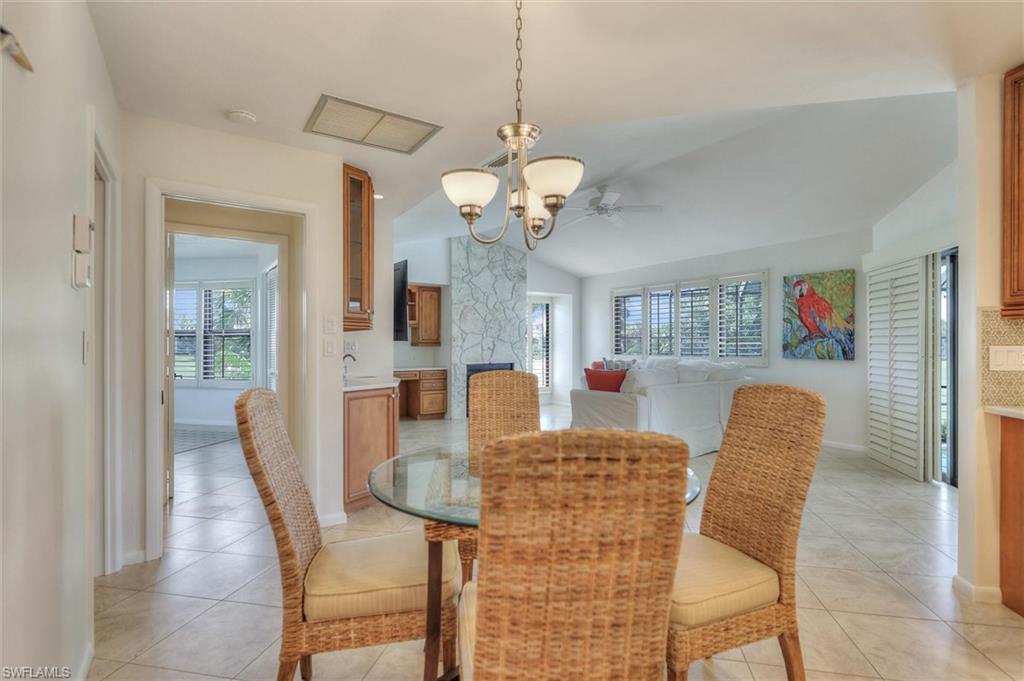 Dining space with recessed lighting, light tile patterned flooring, a chandelier, and ceiling fan