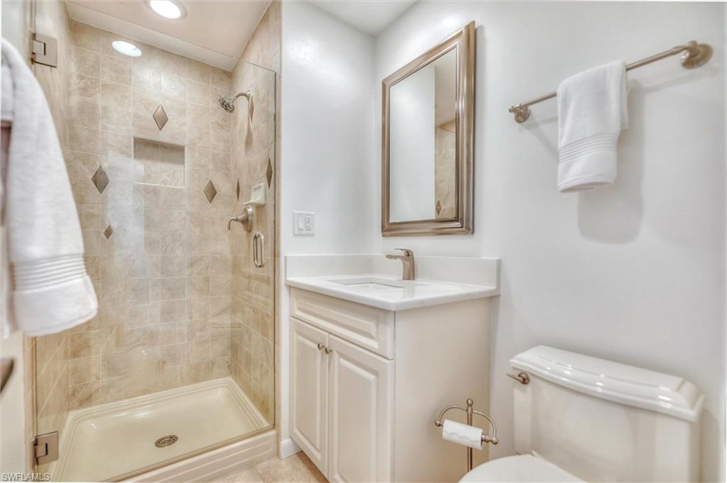 Full bath featuring vanity, enclosed tub / shower combo, tile patterned floors, and recessed lighting