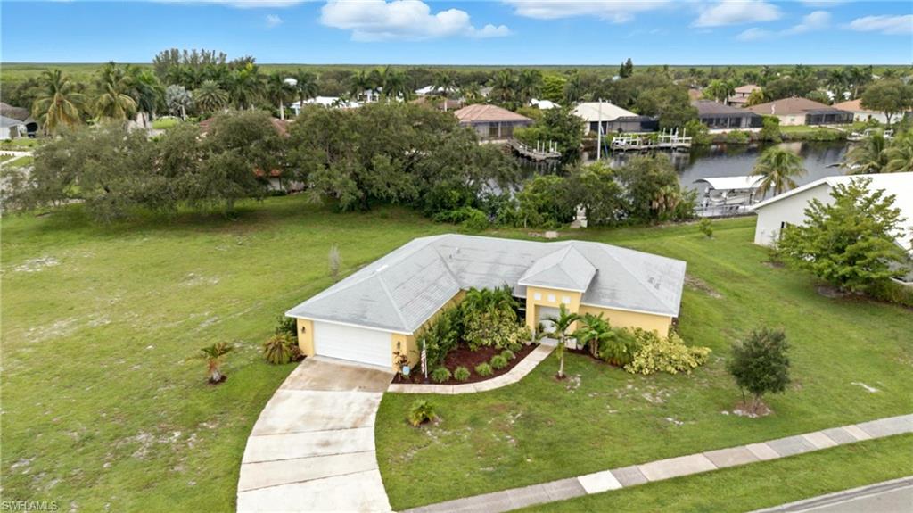 Aerial view of residential area featuring a large body of water