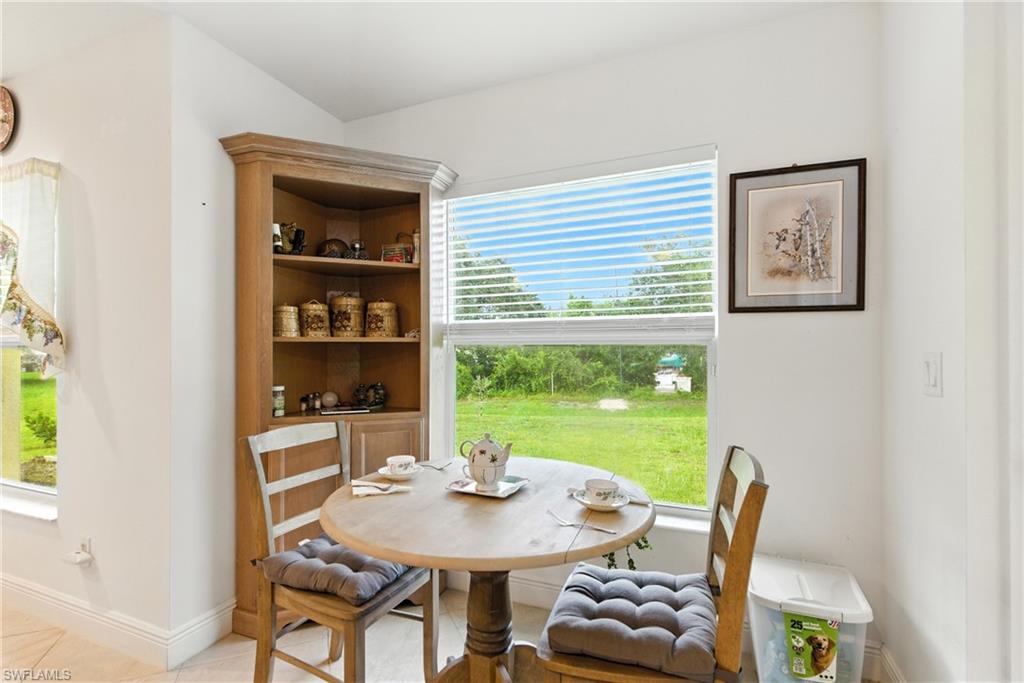Dining space with baseboards and light tile patterned floors