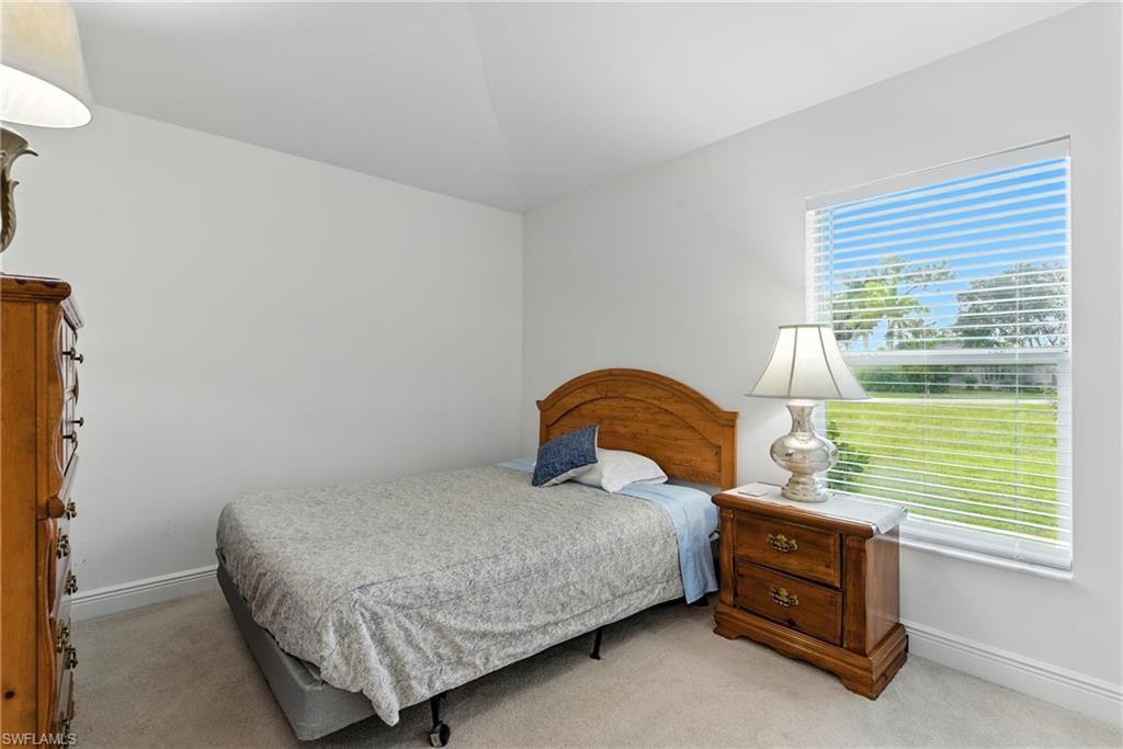 Carpeted bedroom featuring baseboards