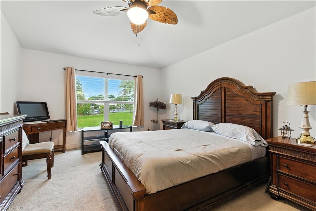 Bedroom featuring light colored carpet and ceiling fan