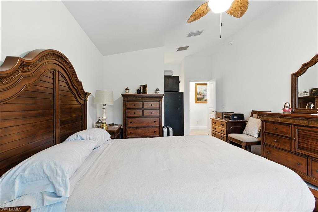 Bedroom featuring ceiling fan and lofted ceiling