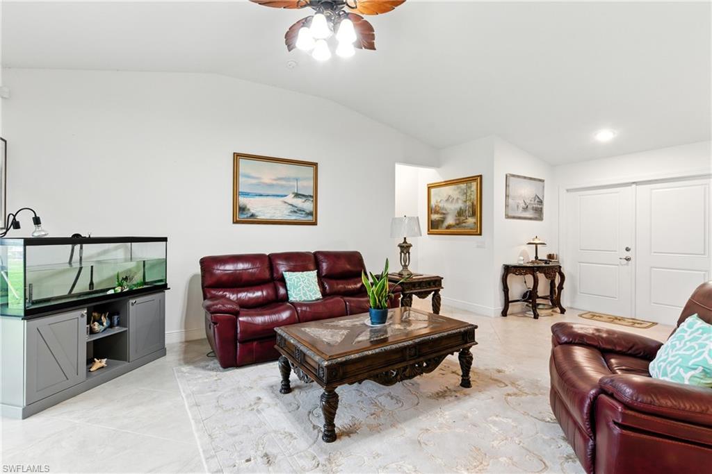 Living area with vaulted ceiling and ceiling fan