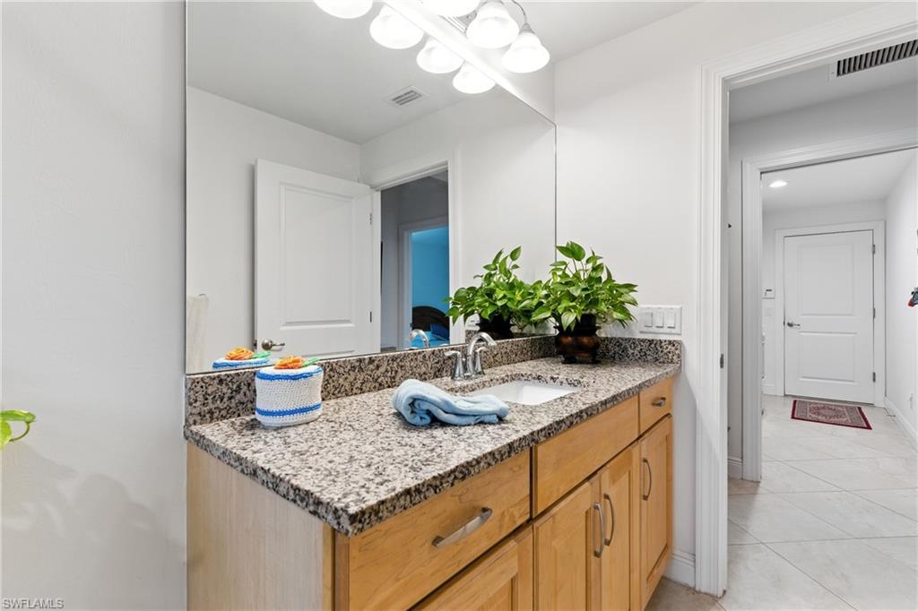 Bathroom with vanity and light tile patterned flooring