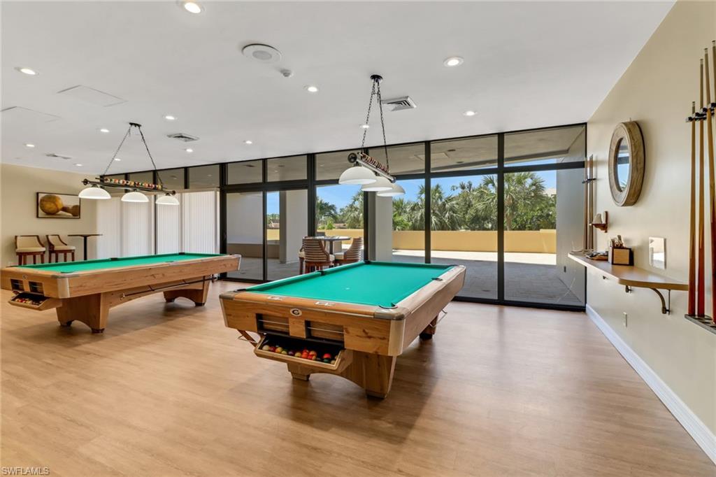 Recreation room featuring plenty of natural light, light wood-type flooring, and pool table