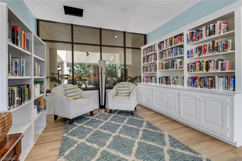 Sitting room with floor to ceiling windows and light hardwood / wood-style flooring