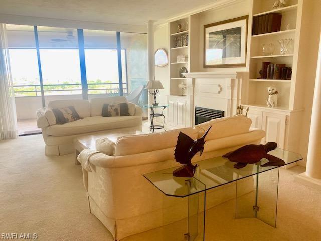 Living room featuring built in features and light colored carpet
