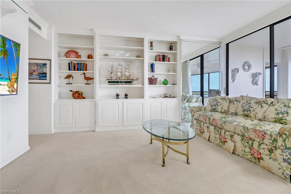 Living room featuring light carpet and built in features