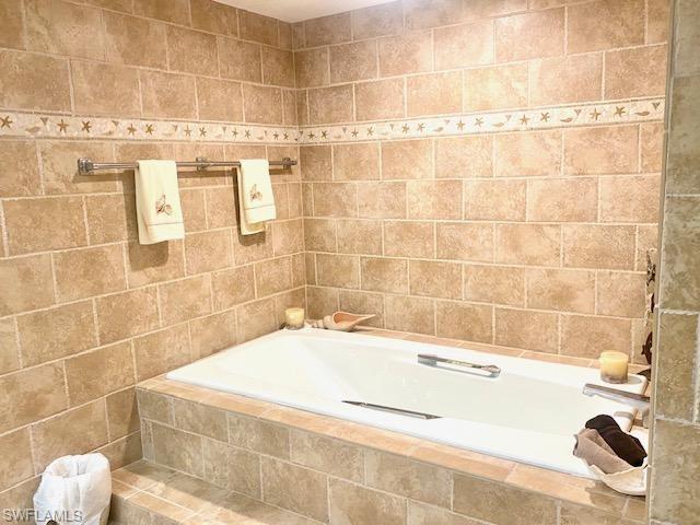 Bathroom featuring tile walls
