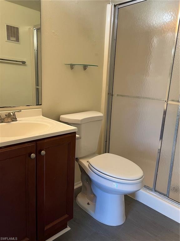 Full bath featuring vanity, wood finished floors, and a shower stall