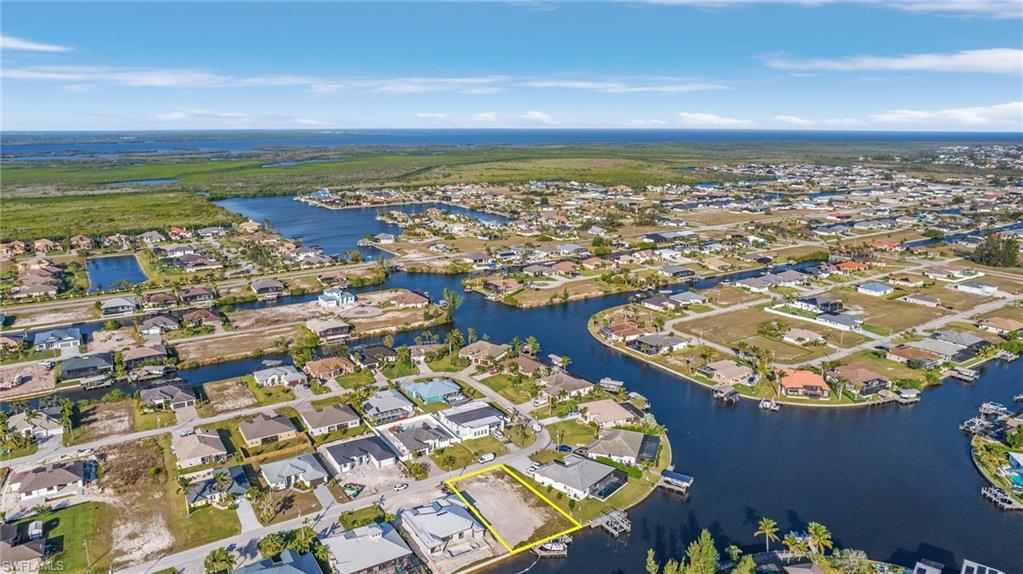 Gulf Access lot with seawall, boat dock and lift northeastern rear exposure, about 20 min by boat to open water. 907 NW 38th Ave, Cape Coral FL 33993