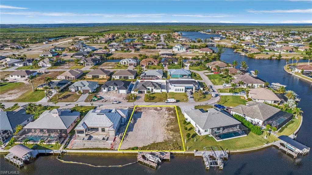 Gulf Access lot with seawall, boat dock and lift northeastern rear exposure, about 20 min by boat to open water. 907 NW 38th Ave, Cape Coral FL 33993