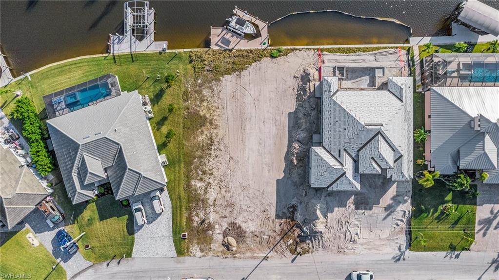 Gulf Access lot with seawall, boat dock and lift northeastern rear exposure, about 20 min by boat to open water. 907 NW 38th Ave, Cape Coral FL 33993