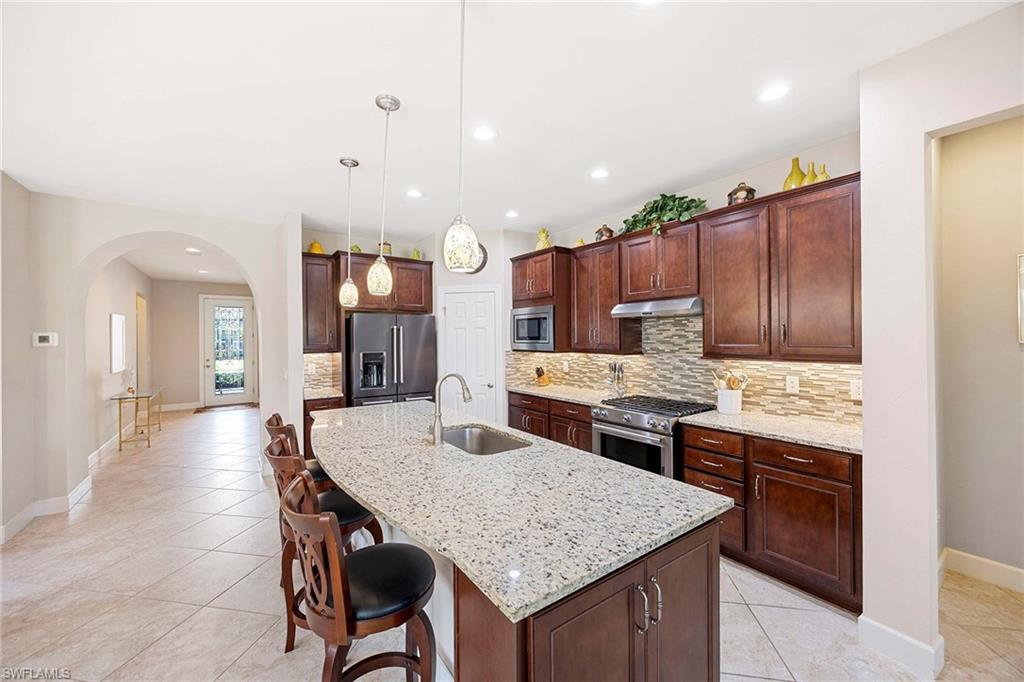 Granite Island Kitchen, Pendant Lighting, Under cabinet lighting, Tiles Backsplash, Walk in Pantry, SS Appliances