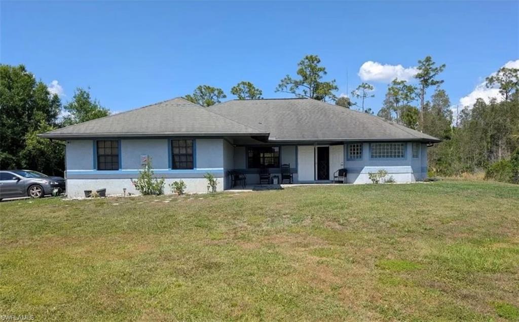 Single story home featuring a front yard and stucco siding