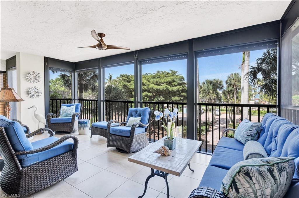 Featuring plenty of natural light, a textured ceiling, floor to ceiling windows, and tile patterned floors