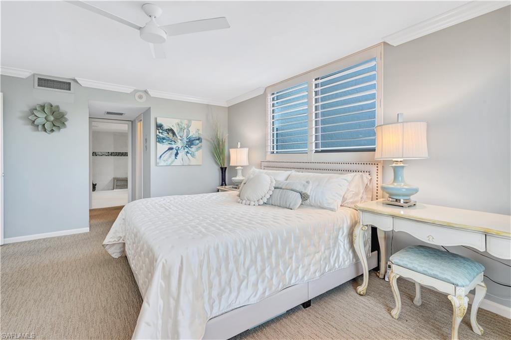 Primary bedroom with crown molding and ceiling fan