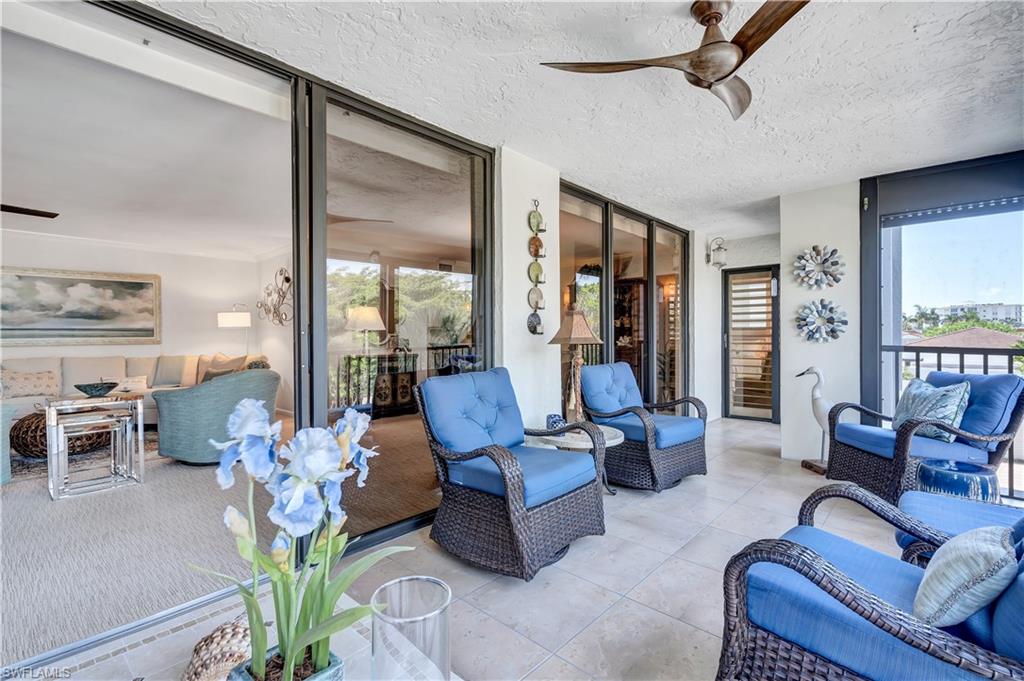 Featuring plenty of natural light, a textured ceiling, floor to ceiling windows, and tile patterned floors