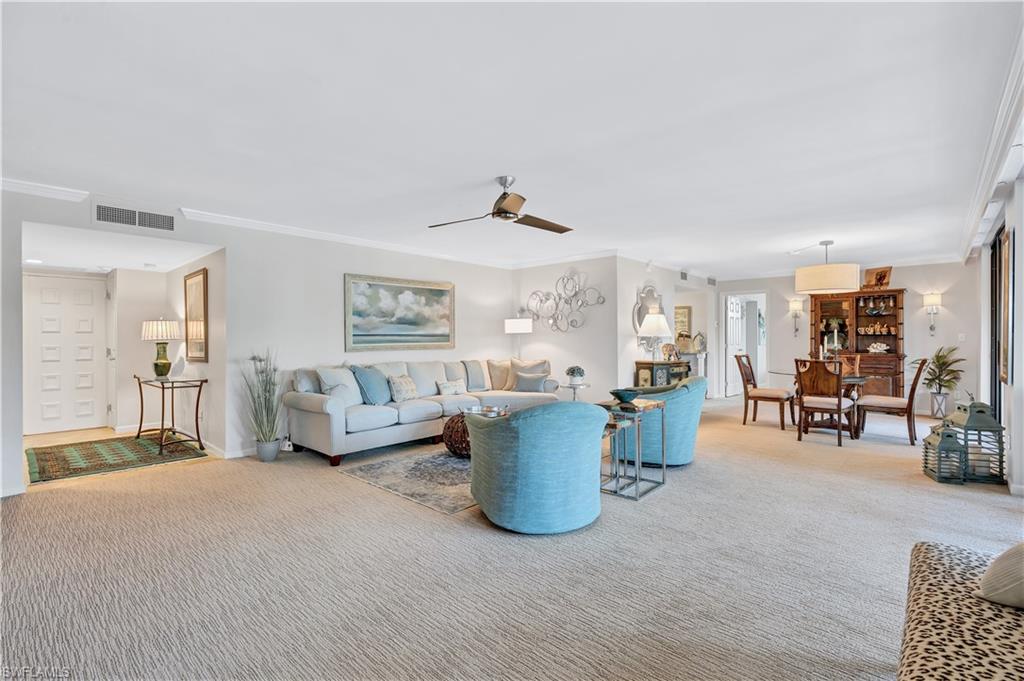 Great room with coastal tones and crown molding
