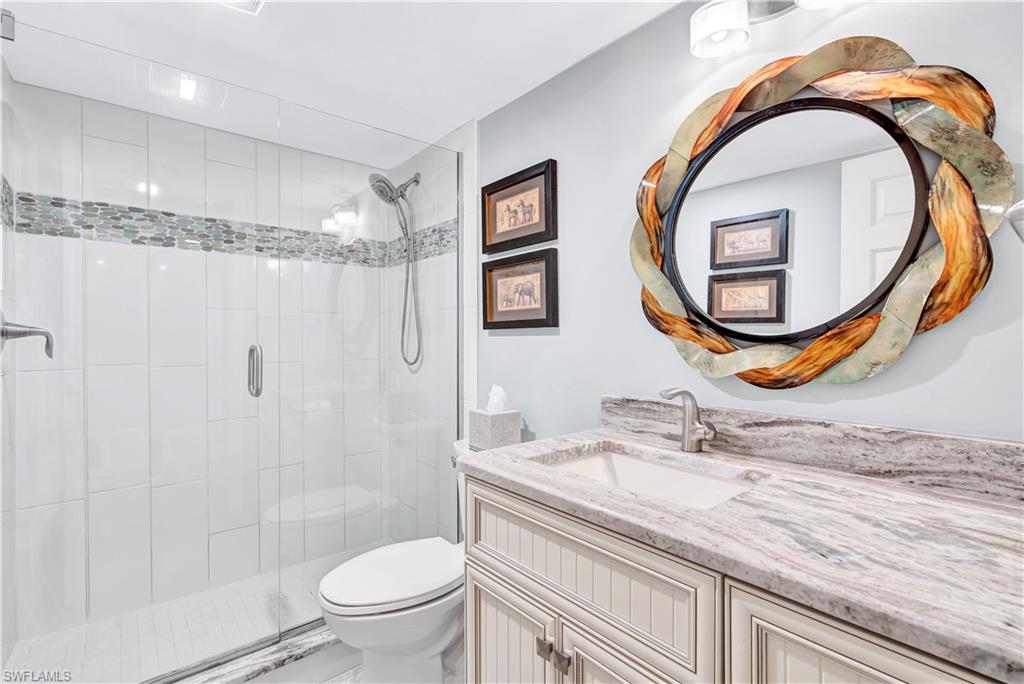 Full bath with vanity and a shower stall