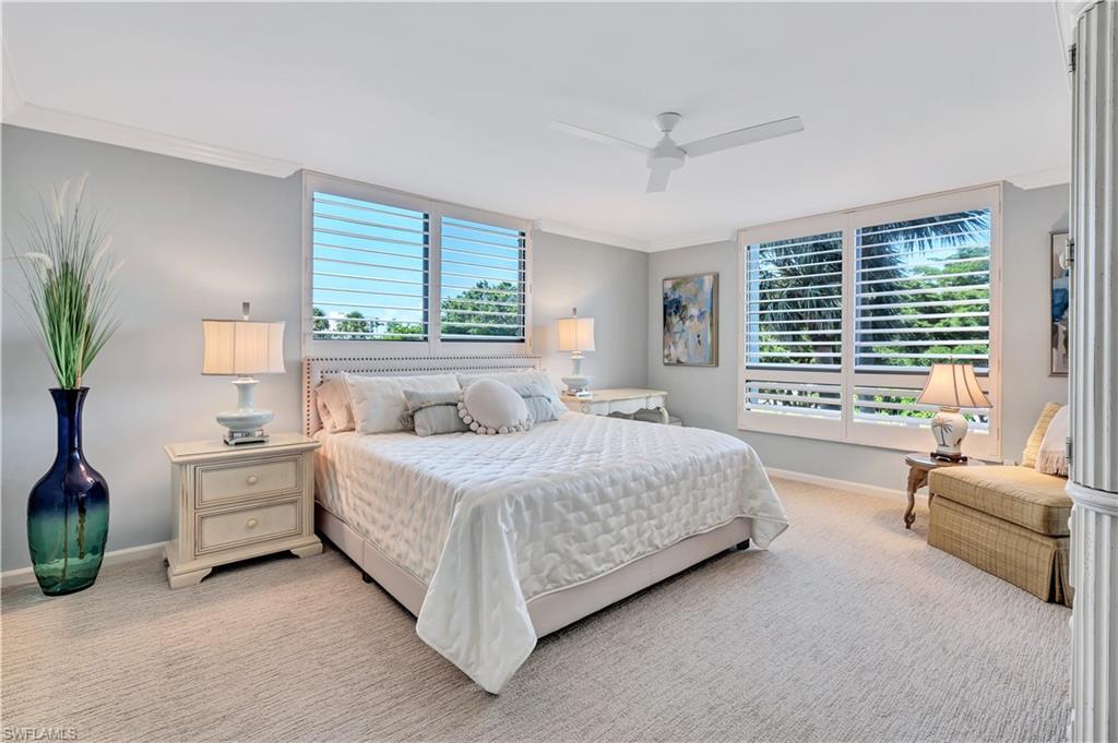 Primary bedroom with crown molding and ceiling fan