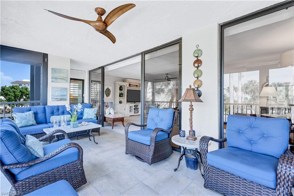 Featuring plenty of natural light, a textured ceiling, floor to ceiling windows, and tile patterned floors