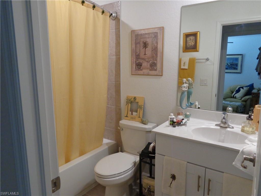 Hall Bathroom with vanity and shower / bathtub combination with curtain