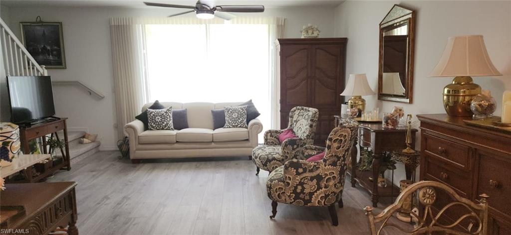Living area with ceiling fan and wood finished floors