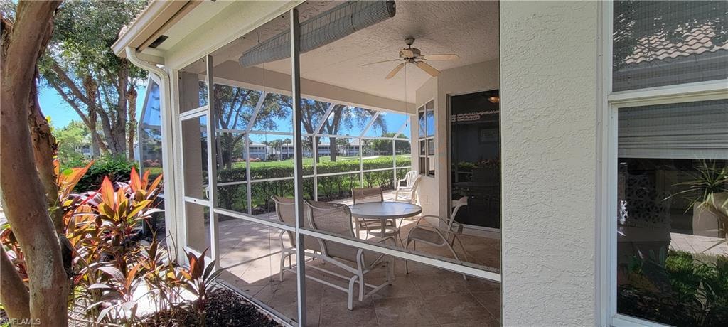 Sunroom / solarium with ceiling fan and a patio area