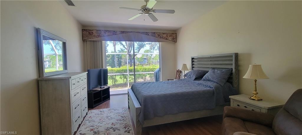 Bedroom with slider to lanai.  View of 8th green on golf course.