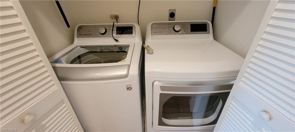 Washroom featuring washing machine and dryer