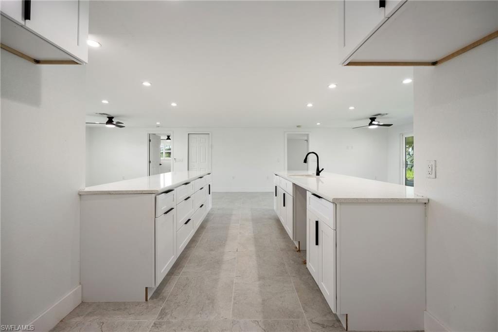 Kitchen featuring ceiling fan, white cabinetry, a peninsula, and recessed lighting