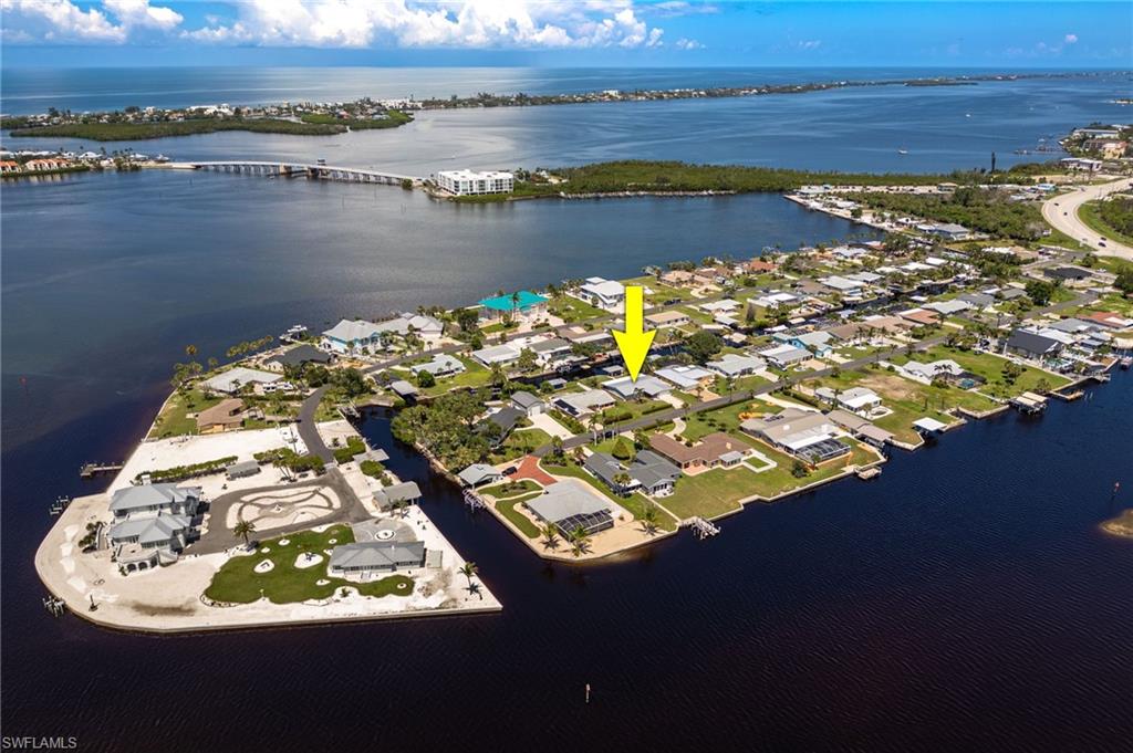 Aerial view of property and peninsula with view of the Gulf of America