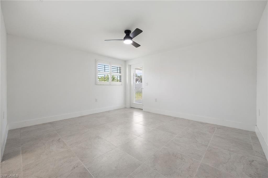 Guest bedroom with walk-in closet, ensuite full bath, and private access to the screened lanai.