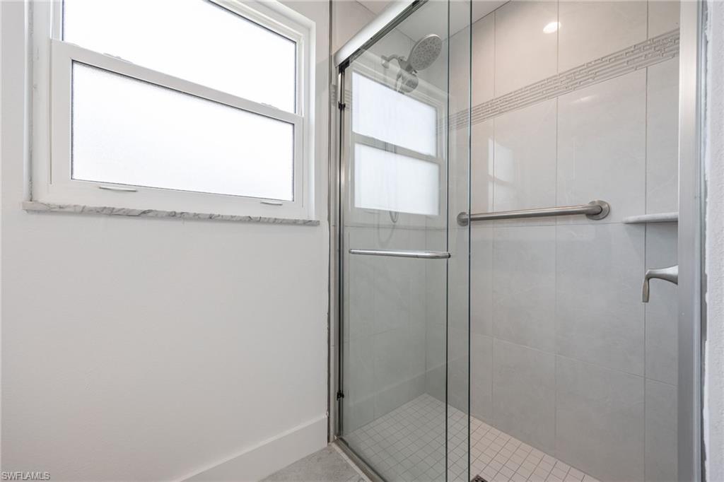 Guest bathroom walk-in shower with glass enclosure.