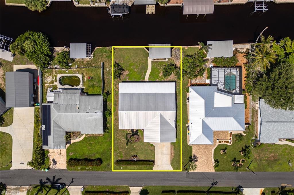 Aerial view of property and surrounding area with property parcel outlined