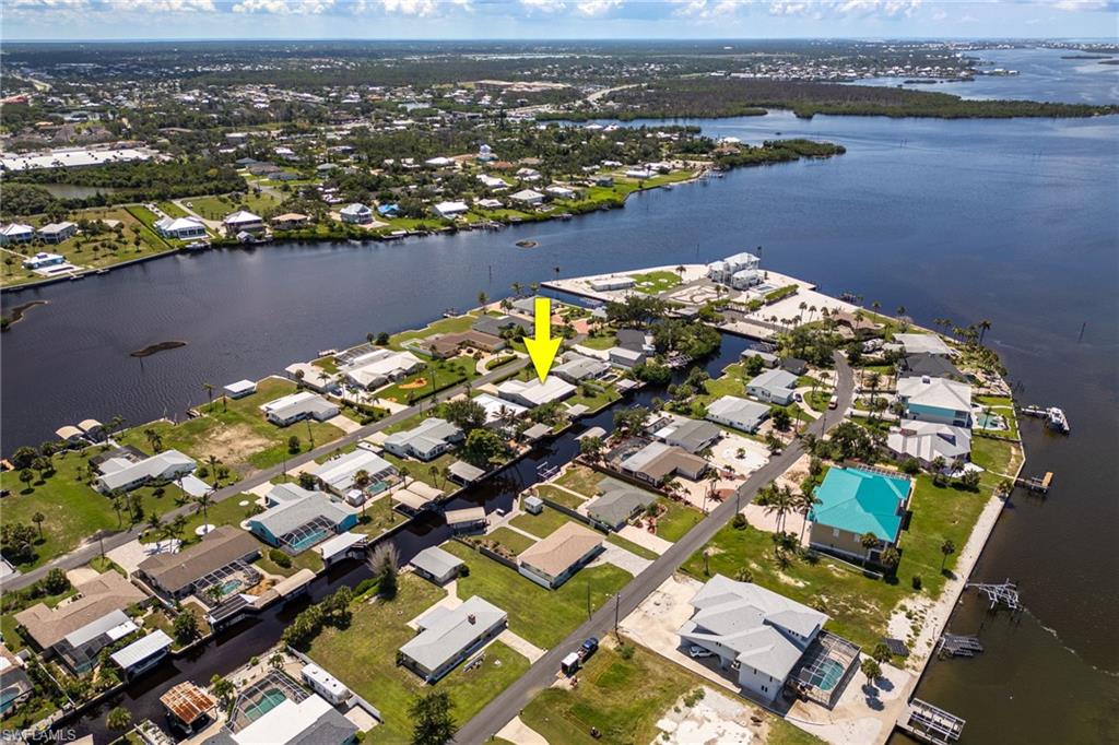 Aerial overview of property's location with a large body of water and nearby suburban area