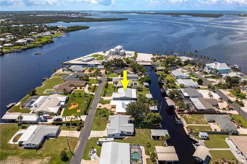 Aerial perspective of suburban area featuring a nearby body of water