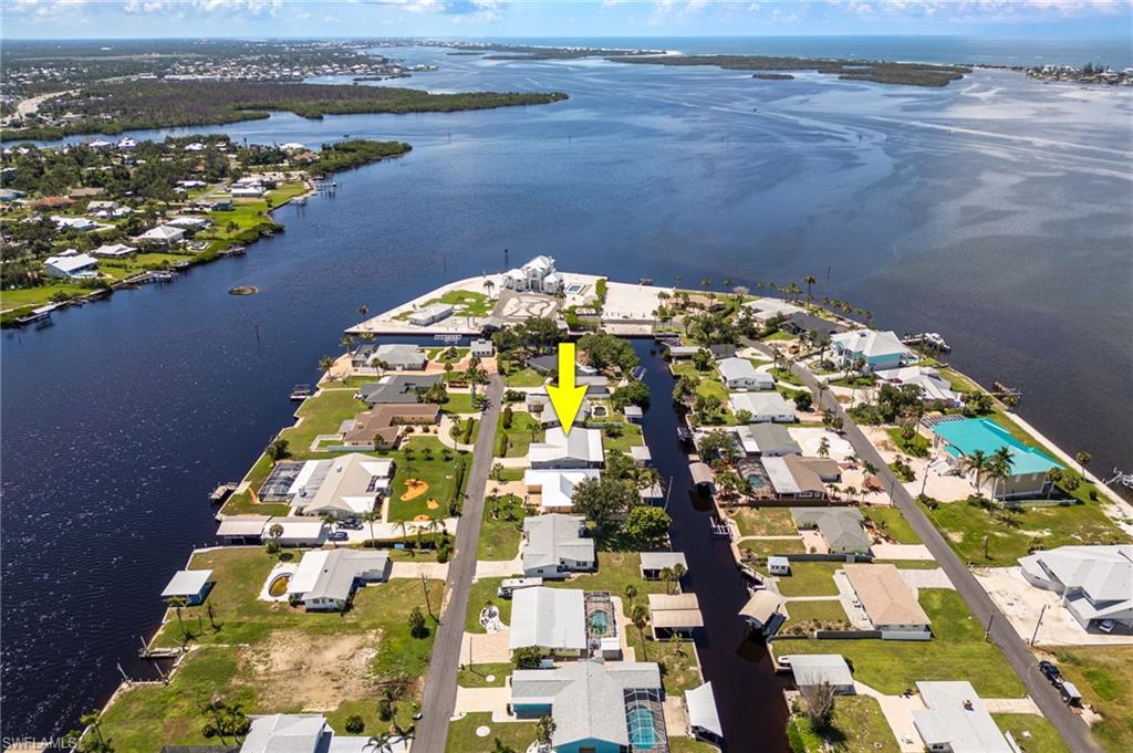 Aerial overview of property's location featuring a large body of water and nearby suburban area