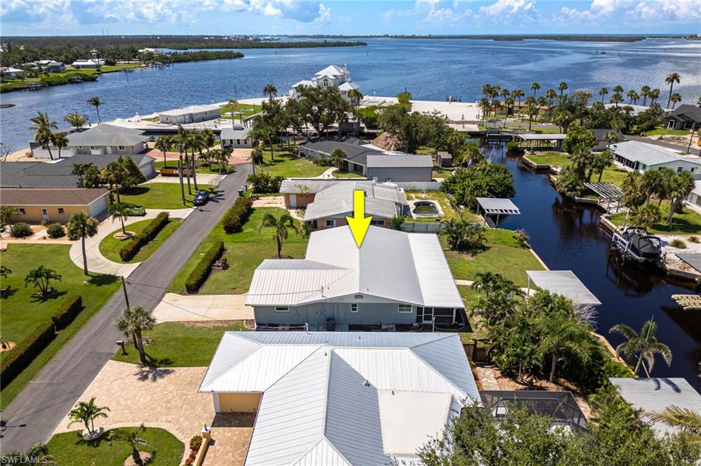Aerial view of residential area featuring a nearby body of water