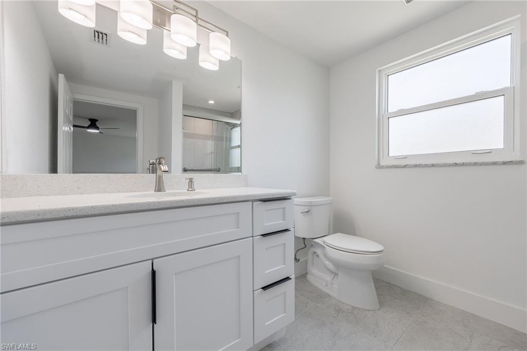 Full guest bathroom with vanity, walk-in shower